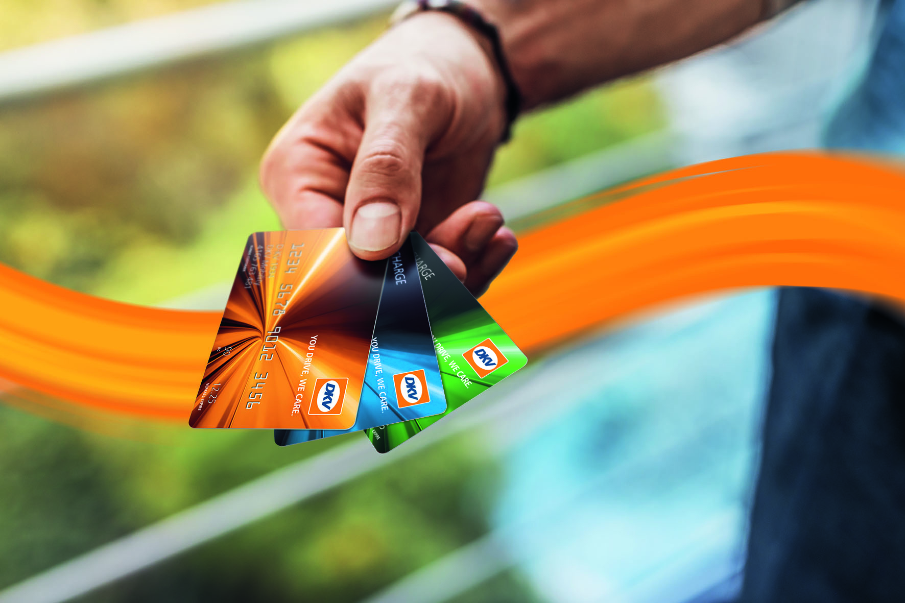 person holding DKV card out of the cars window